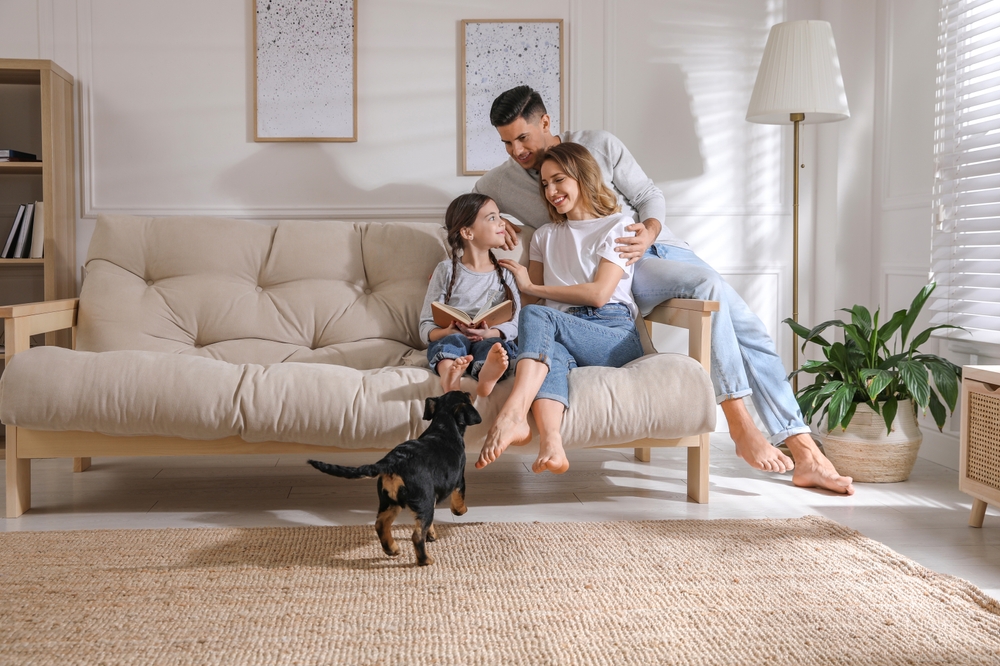 happy,family,on,sofa,and,puppy,in,living,room