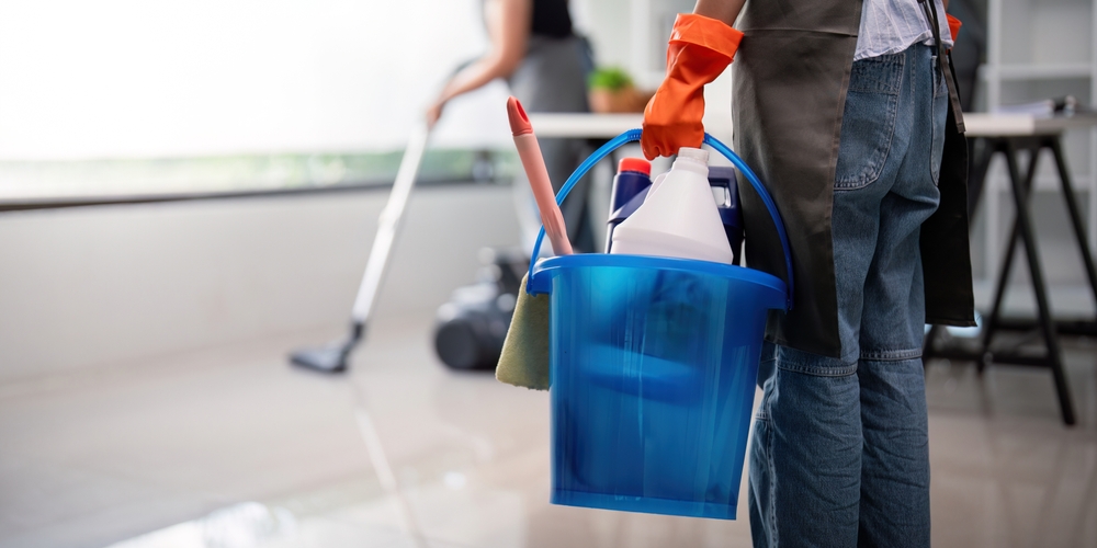 office,cleaner,carrying,bucket,with,cleaning,supplies,and,vacuuming.,concept